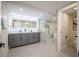 This modern bathroom features sleek fixtures, tiled floors and a glass enclosed shower and tub area at 1102 N Albany Ave, Tampa, FL 33607