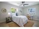 Relaxing bedroom with a work desk, a comfortable bed and bright natural lighting at 1102 N Albany Ave, Tampa, FL 33607