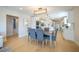 Open concept with dining area, kitchen, and living room, featuring hardwood floors and natural light at 1102 N Albany Ave, Tampa, FL 33607