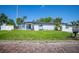Well-manicured lawn and landscaping leading to a charming home with a brick street at 1102 N Albany Ave, Tampa, FL 33607