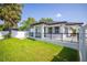 Exterior angle of a well-maintained home with a green lawn and mature trees at 1102 N Albany Ave, Tampa, FL 33607