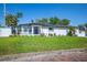 Lovely single-story home with a manicured lawn, fresh landscaping, and welcoming front porch at 1102 N Albany Ave, Tampa, FL 33607