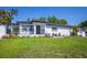 Charming single-story home featuring a freshly landscaped front yard and inviting front porch at 1102 N Albany Ave, Tampa, FL 33607