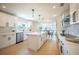 Open kitchen featuring a center island, quartz counters, stainless appliances, and custom cabinets at 1102 N Albany Ave, Tampa, FL 33607