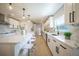 Bright kitchen featuring a center island, quartz counters, stainless appliances, and custom cabinets at 1102 N Albany Ave, Tampa, FL 33607