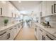 Spacious kitchen featuring quartz counters, stainless appliances, custom cabinets, and breakfast bar at 1102 N Albany Ave, Tampa, FL 33607
