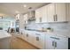 Modern kitchen featuring quartz counters, stainless appliances, custom cabinets, and breakfast bar at 1102 N Albany Ave, Tampa, FL 33607