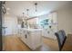 Bright kitchen featuring a center island, quartz counters, stainless appliances, and custom cabinets at 1102 N Albany Ave, Tampa, FL 33607