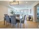 Open-concept living and dining area with modern lighting, wood floors, and lots of natural light at 1102 N Albany Ave, Tampa, FL 33607