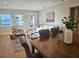 Bright living room with wood floors, white sofa, stylish seating, and lots of natural light from windows and doors at 1102 N Albany Ave, Tampa, FL 33607