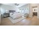 Bright bedroom featuring a ceiling fan, hardwood floors, and natural light at 1102 N Albany Ave, Tampa, FL 33607