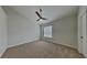 Cozy bedroom with carpet flooring, a ceiling fan, natural light, and neutral decor at 12426 Country White Cir, Tampa, FL 33635