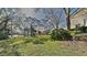 Spacious front yard with lush green grass and mature trees, creating a serene and inviting outdoor space at 12426 Country White Cir, Tampa, FL 33635