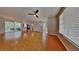 Spacious living room featuring hardwood floors, ceiling fan, and access to the outdoor patio at 12426 Country White Cir, Tampa, FL 33635
