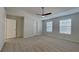 Comfortable main bedroom with vaulted ceilings, ceiling fan, plush carpeting, and natural light at 12426 Country White Cir, Tampa, FL 33635