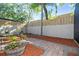 Private, brick-paved backyard patio with lush mulch, mature trees, and new perimeter fence at 12605 Catamaran Pl, Tampa, FL 33618