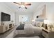 Stylishly furnished bedroom featuring a ceiling fan, ample natural light, and serene decor at 12605 Catamaran Pl, Tampa, FL 33618