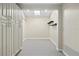 Spacious walk-in closet with ample storage including shelves, cabinets, a skylight, and neutral color palette at 12605 Catamaran Pl, Tampa, FL 33618