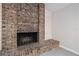 Close up of the brick fireplace with a hearth and decorative white wood paneling at 12605 Catamaran Pl, Tampa, FL 33618