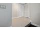 Bright hallway featuring neutral paint, white trim, tile floors, and multiple closets for storage at 12605 Catamaran Pl, Tampa, FL 33618