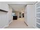 Bright hallway showcasing an open floor plan, kitchen island, and access to multiple rooms at 12605 Catamaran Pl, Tampa, FL 33618