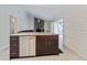 Open kitchen design with granite countertop island, stainless steel appliances, and view into the living area at 12605 Catamaran Pl, Tampa, FL 33618