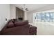 Inviting living room with large windows, flowing curtains, brick fireplace, and a plush sectional sofa at 12605 Catamaran Pl, Tampa, FL 33618