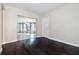 Large, bright living room featuring wood floors, view into dining area, and a white door at 12605 Catamaran Pl, Tampa, FL 33618