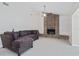Bright living room featuring a brick fireplace, ceiling fan, and comfortable sectional sofa at 12605 Catamaran Pl, Tampa, FL 33618