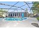 Spacious backyard pool with large patio, screen enclosure, and a view of the house at 12605 Catamaran Pl, Tampa, FL 33618