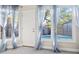 Bright sunroom with tile floor, sheer curtains and views of the pool area and screened enclosure at 12605 Catamaran Pl, Tampa, FL 33618