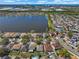 Aerial view of neighborhood and lake showing proximity to business and industrial areas in the distance at 12802 Lake Vista Dr, Gibsonton, FL 33534