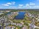 Aerial view of a community surrounding a lake, showcasing the neighborhood layout and scenic beauty at 12802 Lake Vista Dr, Gibsonton, FL 33534