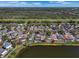Community aerial view showcasing the neighborhood, homes and surrounding treeline in the background at 12802 Lake Vista Dr, Gibsonton, FL 33534