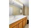 Bathroom vanity with bright lighting and a large mirror at 12802 Lake Vista Dr, Gibsonton, FL 33534