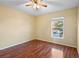 Bedroom with wood flooring, ceiling fan, and window views at 12802 Lake Vista Dr, Gibsonton, FL 33534