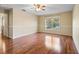 Bedroom featuring laminate flooring, a ceiling fan, a large window, and natural light at 12802 Lake Vista Dr, Gibsonton, FL 33534