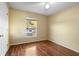 Cozy bedroom with wood floors, window, and neutral paint at 12802 Lake Vista Dr, Gibsonton, FL 33534