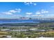 Scenic view of a cityscape across the water, with lush greenery in the foreground at 12802 Lake Vista Dr, Gibsonton, FL 33534