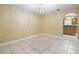 Inviting dining room featuring tile floors, chandelier lighting, and seamless access to the kitchen at 12802 Lake Vista Dr, Gibsonton, FL 33534