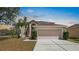 Spacious two-story home featuring a wide driveway, attached two-car garage, and manicured landscaping at 12802 Lake Vista Dr, Gibsonton, FL 33534