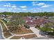 Two-story home with mature trees, large front lawn and paved driveway leading to attached two-car garage at 12802 Lake Vista Dr, Gibsonton, FL 33534