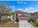 Inviting two-story home with a manicured lawn and a spacious two-car garage, nestled under a bright, partly cloudy sky at 12802 Lake Vista Dr, Gibsonton, FL 33534