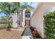 Charming home entrance featuring a walkway with landscaped flowerbeds leading to a classic two-story facade at 12802 Lake Vista Dr, Gibsonton, FL 33534