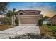 Well-maintained home with a neutral color scheme, wide driveway, and a two-car garage at 12802 Lake Vista Dr, Gibsonton, FL 33534