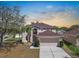 Elegant two-story home with large windows, a two-car garage, and palm trees in the front yard at 12802 Lake Vista Dr, Gibsonton, FL 33534