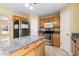 Bright kitchen features stainless appliances, granite countertops, kitchen island and tile floors at 12802 Lake Vista Dr, Gibsonton, FL 33534