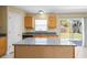 Kitchen featuring granite countertops, an island, and sliding door to backyard at 12802 Lake Vista Dr, Gibsonton, FL 33534