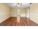A well-lit living room showcasing laminate flooring, a ceiling fan, and chair rail at 12802 Lake Vista Dr, Gibsonton, FL 33534