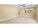 Spacious living room with tile flooring, ceiling fan, and arched doorways providing seamless flow at 12802 Lake Vista Dr, Gibsonton, FL 33534
